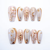 Galaxy theme press-on nails with gold constellation designs on silver glitter base