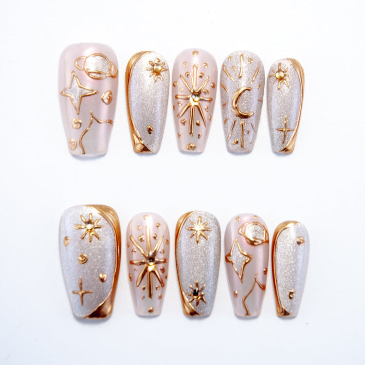 Galaxy theme press-on nails with gold constellation designs on silver glitter base