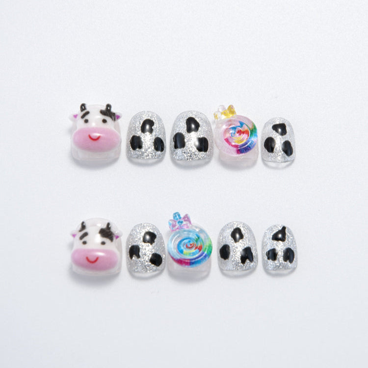 Cute cow print press-on nails with 3D cow face and rainbow candy design