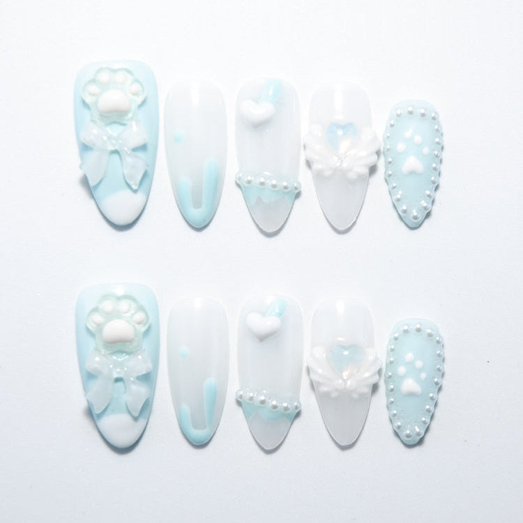 Handmade blue and white nails with pearl heart details and soft gradient tips