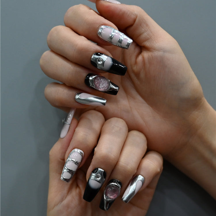Futuristic style press-on nails with metallic silver accents, gradient tips, and gemstone decor