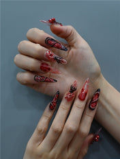 Long stiletto handmade nails with 3D rose, chain, and skull accents