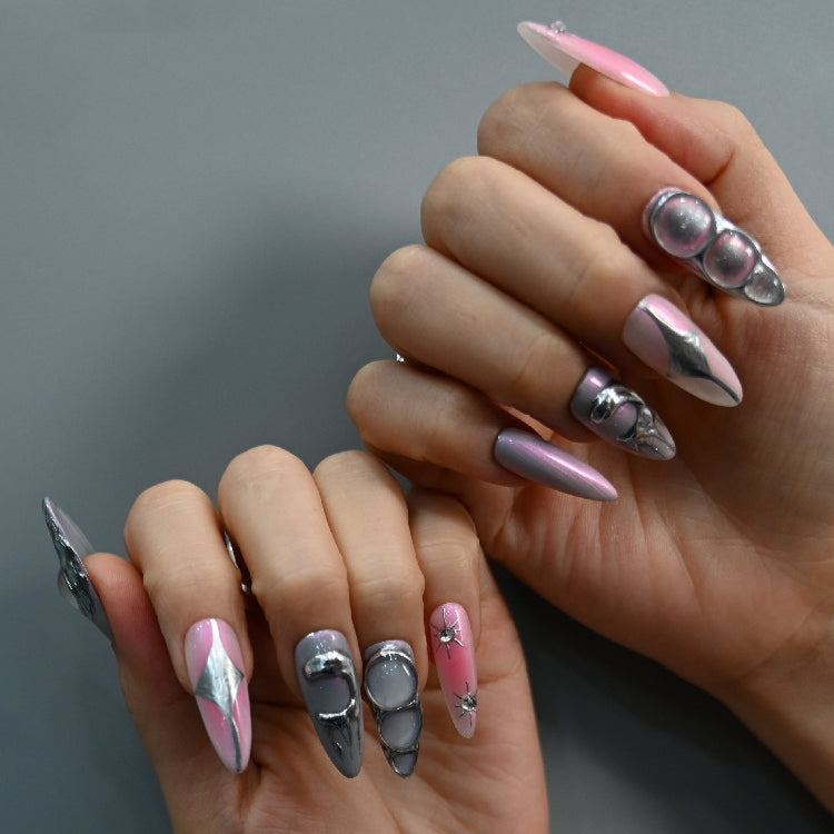 Edgy futuristic nails with silver sculpted details and shiny purple-pink cat eye effect