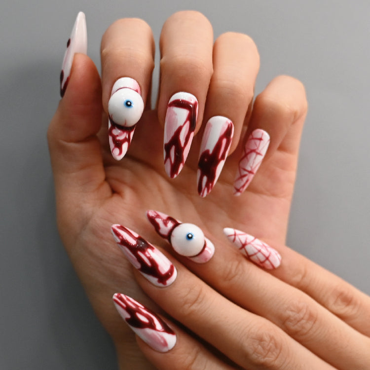 Scary handmade almond nails with red blood splatter and creepy art