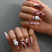 Horror themed press-on nails with dripping blood and spooky eyeball charm