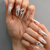 Handmade wedding press-on nails with delicate flower art and sparkly rhinestones