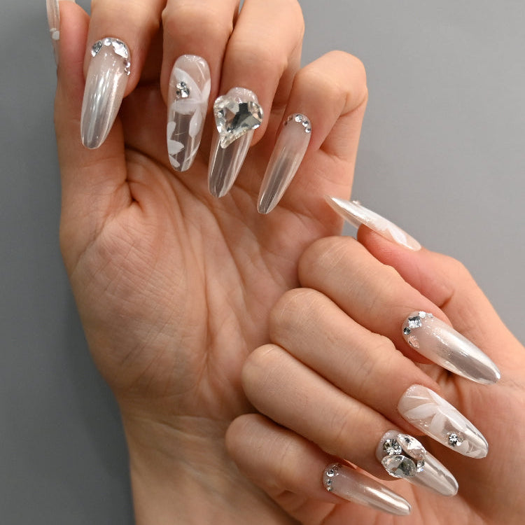 Handmade wedding press-on nails with delicate flower art and sparkly rhinestones