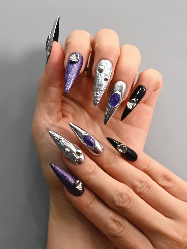 Galaxy-inspired nails with purple shimmer and molten silver details