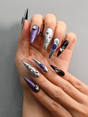 Galaxy-inspired nails with purple shimmer and molten silver details