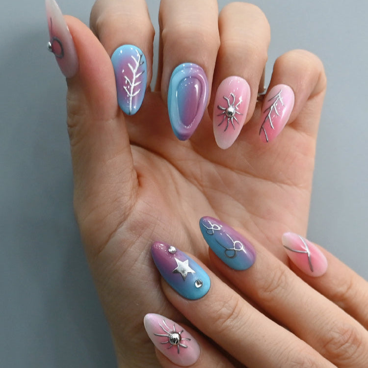 Handmade nails with bow, star, and spider design in pastel gradient