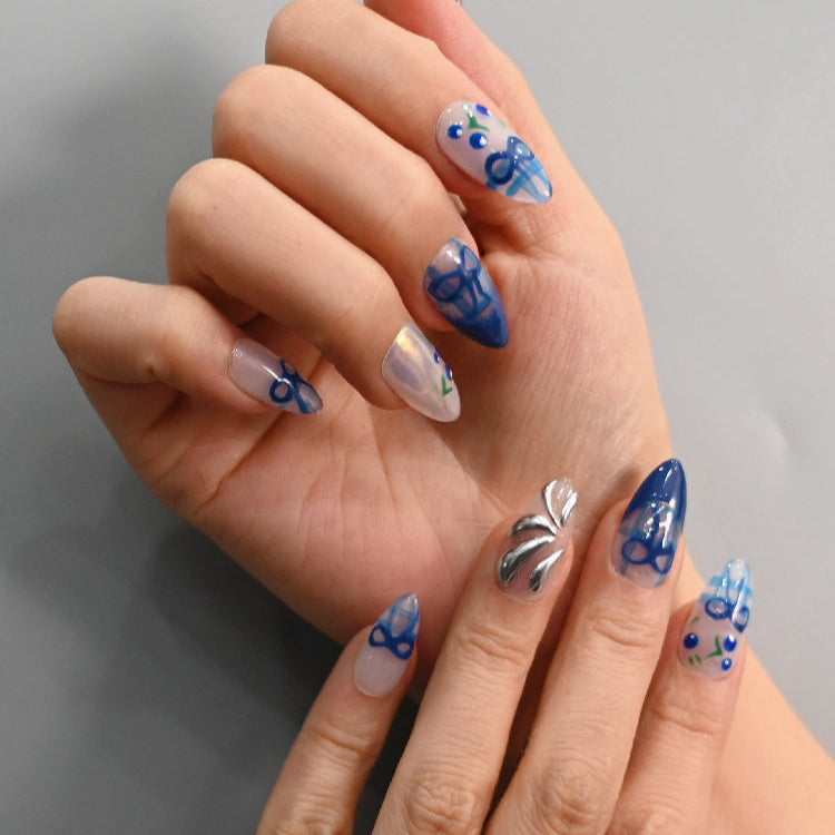 Handmade plaid press-on nails with navy bows, 3D silver charm, and blueberry details