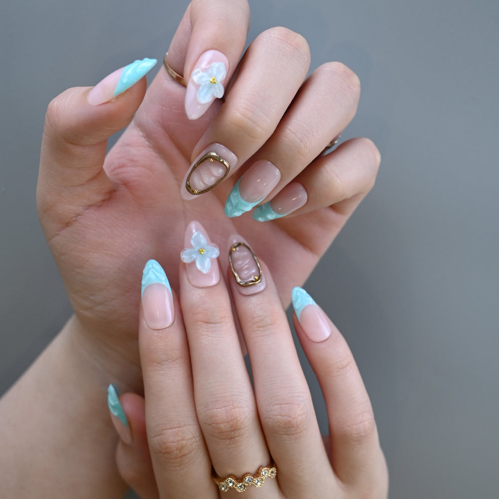 Turquoise gradient nails with pearlized floral design and gold seashell frame
