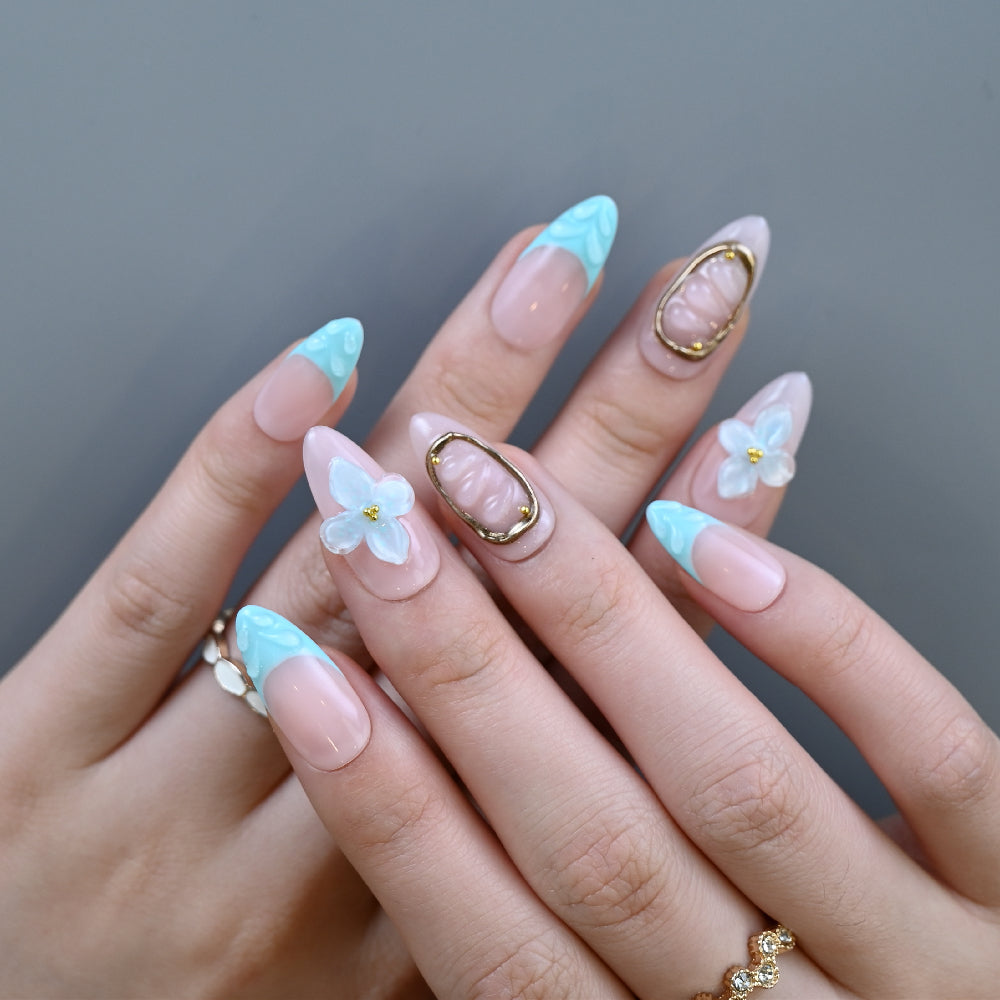 Beach vacation press-on nails with seashell charm and flower embellishments
