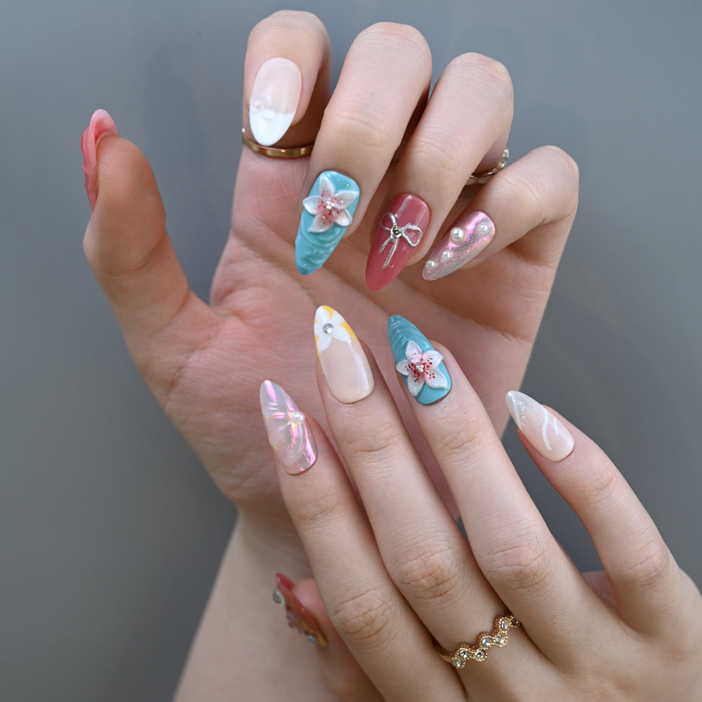 Tropical beach press-on nails in coral pink and aqua blue with floral design