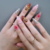 Handmade almond nails featuring ombre pink-red design, shimmer swirl, and flower