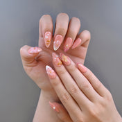 Romantic blush nude press-on nails with spring flowers and delicate pearls