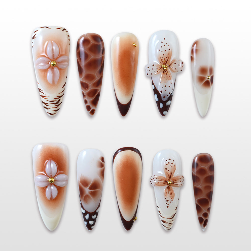 Long stiletto press-on nails with 3D flower design and brown giraffe print accents