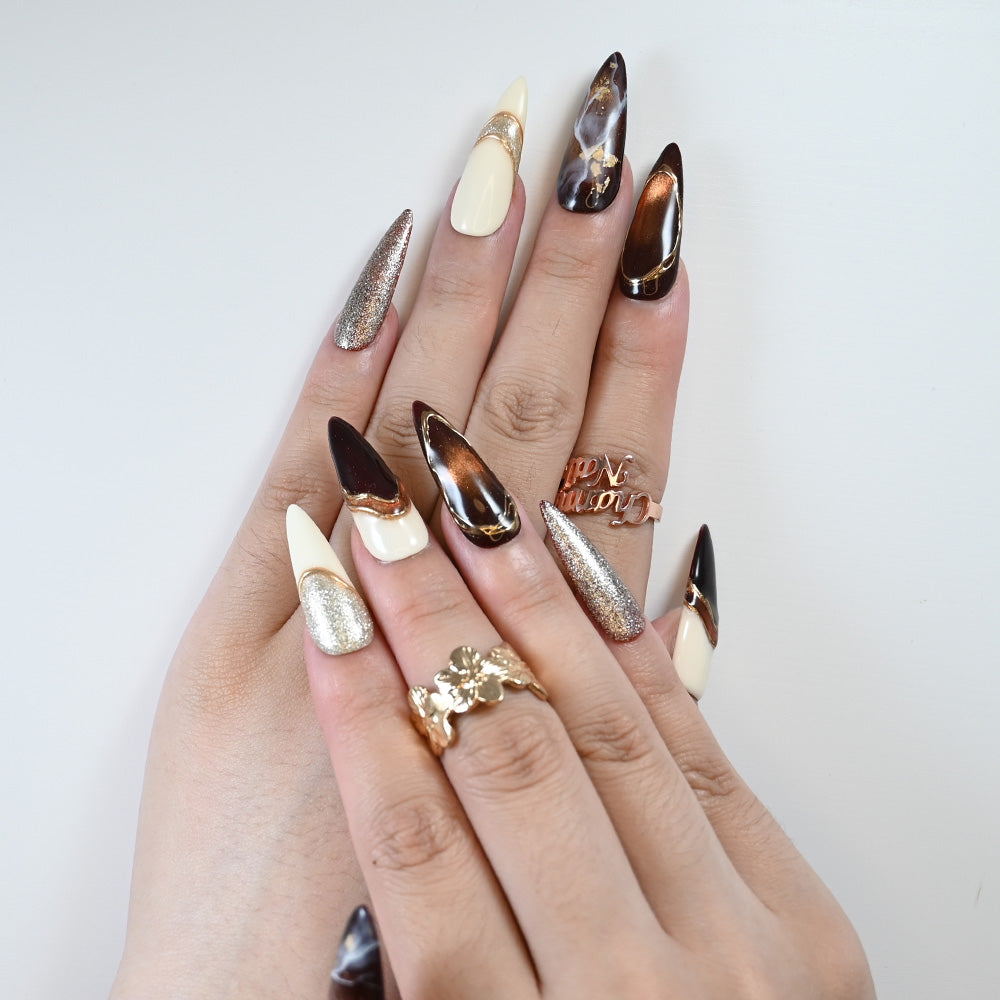 Luxury salon-quality press-on nails with marble swirl, glitter tips, and gold foil
