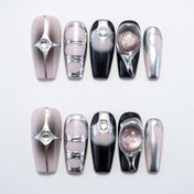 Handmade metallic nails in nude, black, and silver with futuristic geometric designs