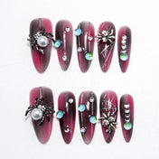 Halloween press-on nails with 3D spider, pearl, and gemstone accents