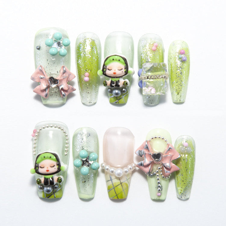 Green ombre press-on nails with 3D doll charm and pink bow accents