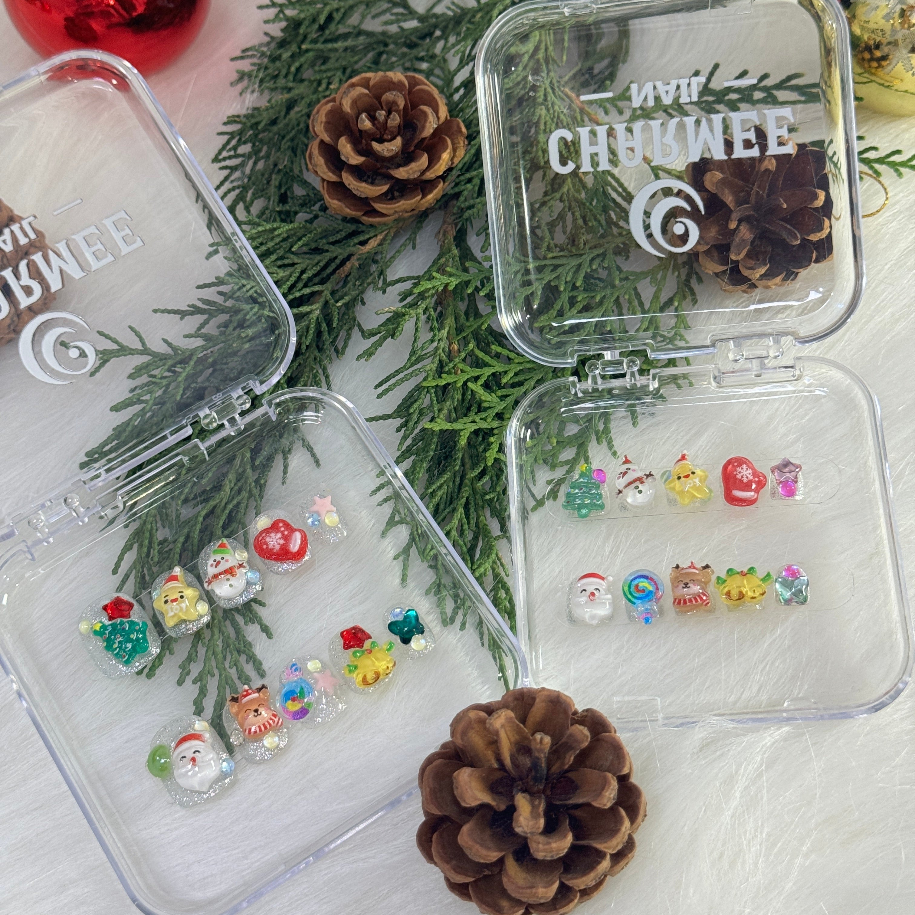 Colorful Christmas nails with 3D reindeer, bells, and lollipop designs