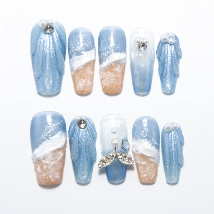 Beach theme press-on nails with palm trees, dolphins, and ocean waves