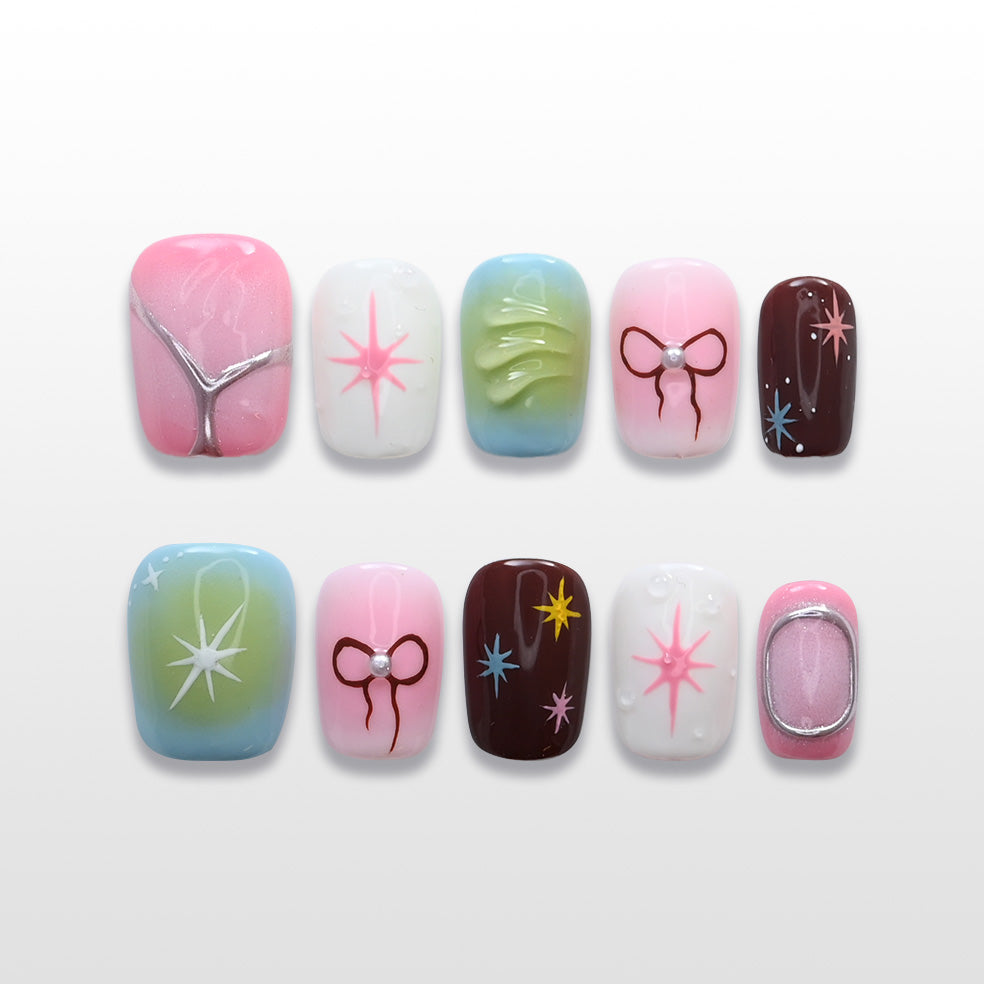 Colorful press-on nails with hand-painted stars, bows, and pastel gradients